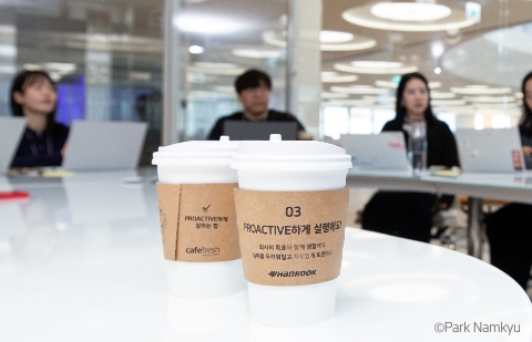 Even the paper cup sleeves in the company's café feature the 'How to Work Proactively' series